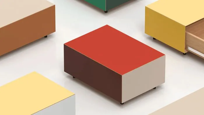 Collection of minimalist furniture pieces in vibrant colors including red, yellow, brown, and green, displayed in a clean white space.