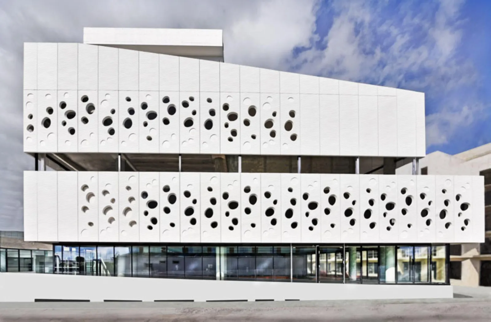 Front facade of Bordeaux's Mer Marine Museum featuring white perforated panels with circular bubble patterns, modern minimalist architecture