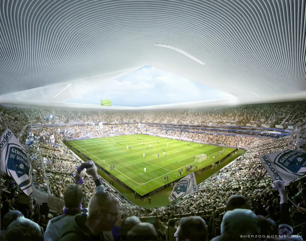 Panoramic view of Stade Atlantique Bordeaux Métropole filled with spectators during a football match, showing the green pitch in the center and the stadium's distinctive architecture.