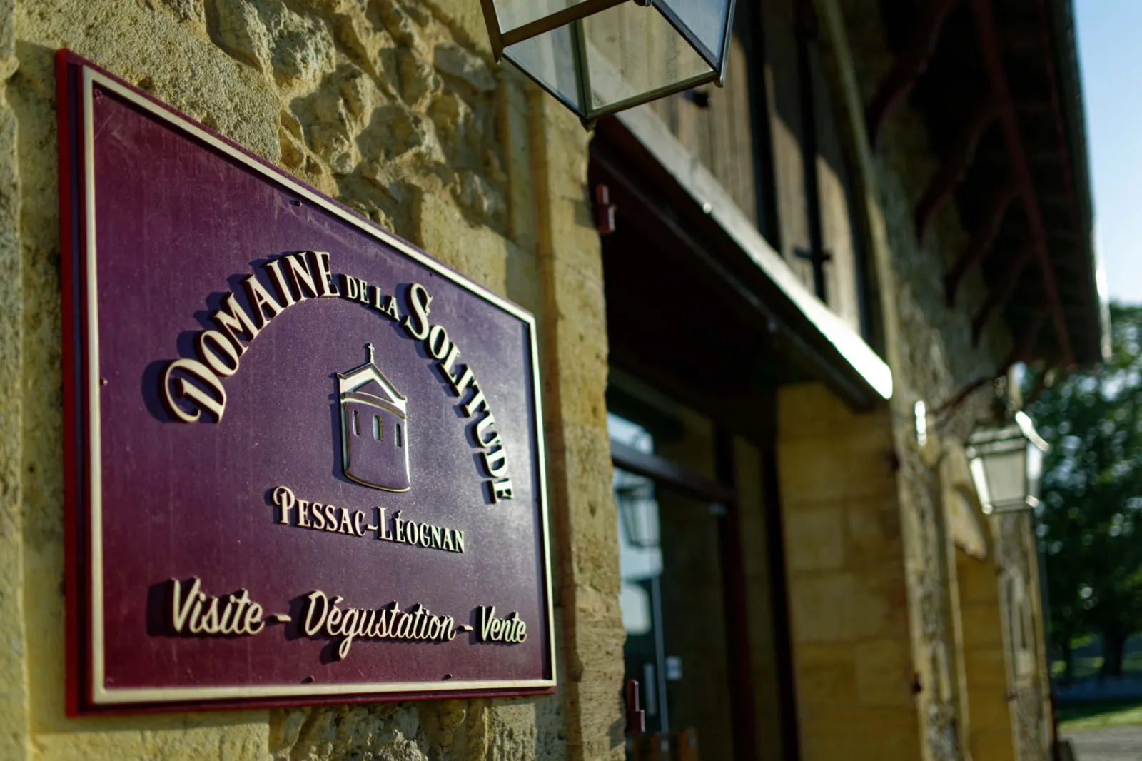 Signage for Domaine de la Solitude in Pessac-Léognan, Bordeaux, indicating wine tasting, tours, and sales services