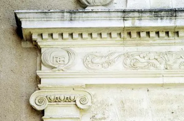 Architectural detail of an ornamental cornice with white stone Ionic capital from Château La Haye in Bordeaux