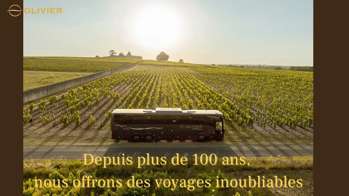 A black Olivier coach parked on a road surrounded by lush vineyards in the Bordeaux region, with the tagline « For over 100 years, we offer unforgettable journeys »