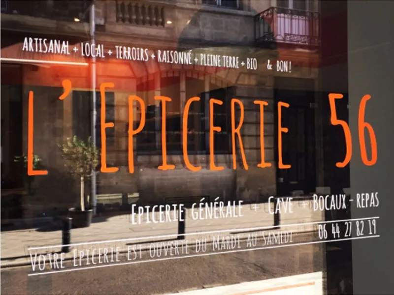 Storefront of L'Epicerie 56, a general grocery store in Bordeaux offering artisanal, local, and organic products, with wine cellar and dining service.