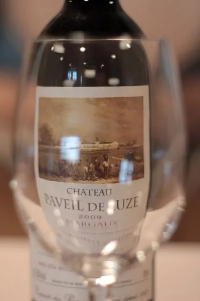 Bottle of red wine Château Paveil de Luze 2008, Margaux appellation, featuring a label with a historical harvest scene illustration.