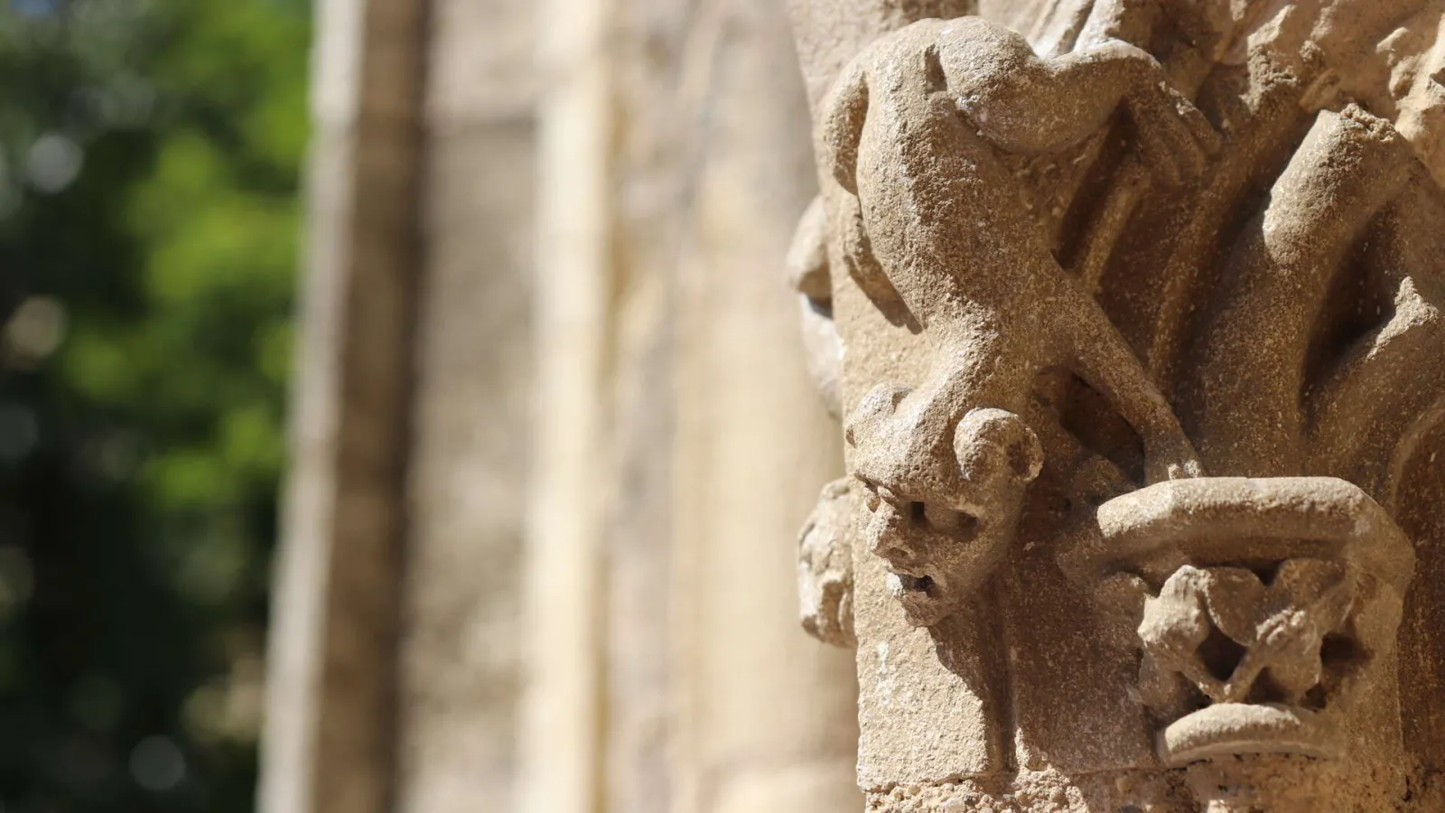 Stone carved ornamental face detail on the facade of Saint-Pierre Church in Bordeaux