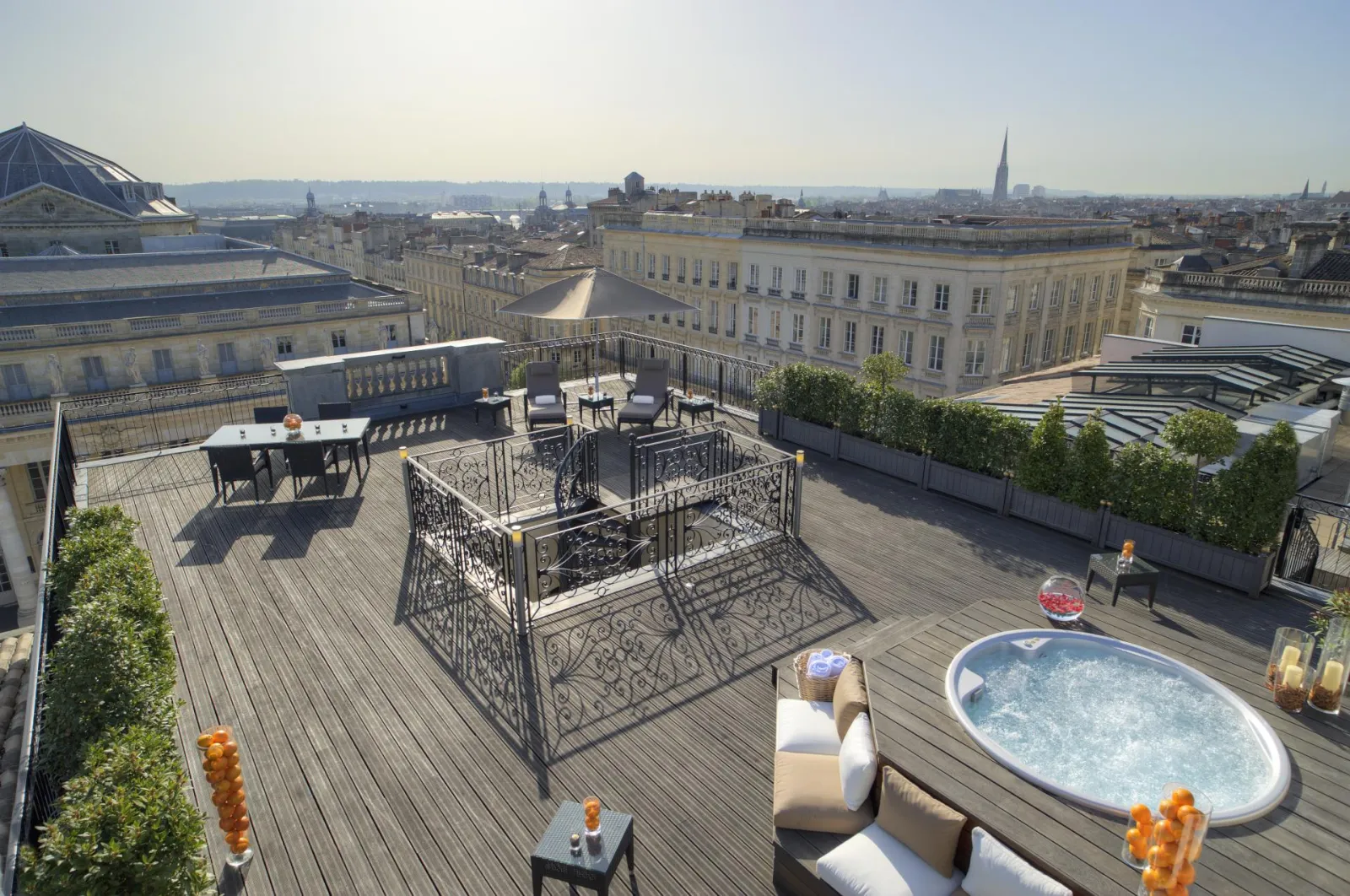 Panoramic spa terrace at Intercontinental Grand Hotel Bordeaux featuring hot tub, lounge furniture and cityscape view