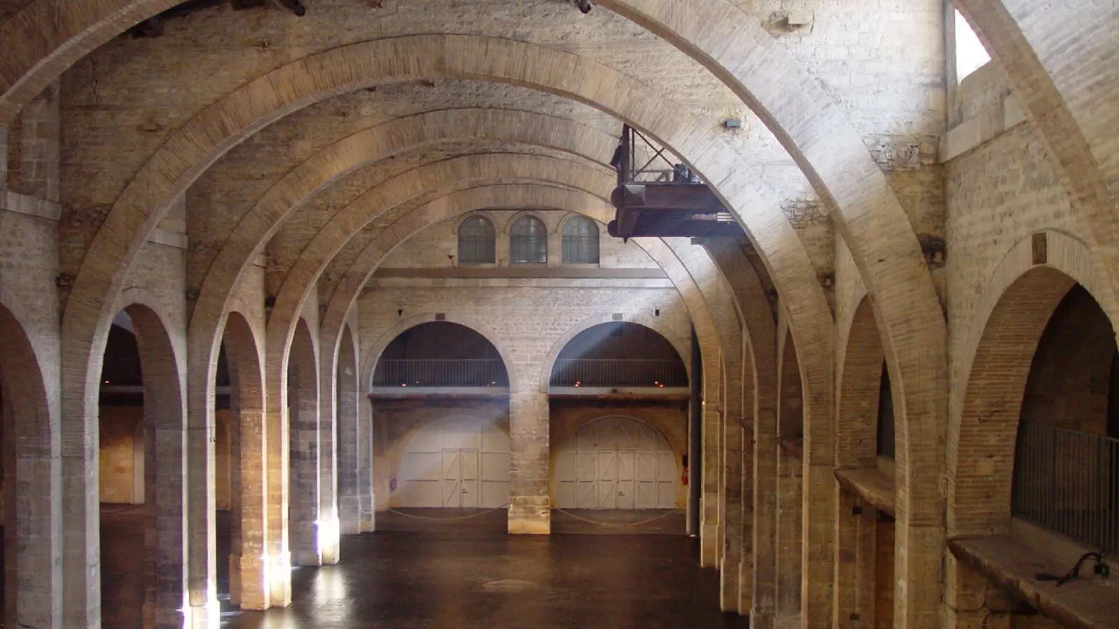 Interior of the CAPC Museum of Contemporary Art in Bordeaux featuring characteristic brick vaults and columns of a converted industrial building.