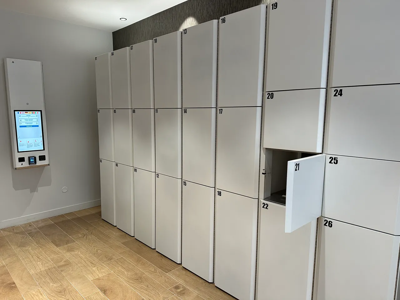 Numbered automated storage lockers in a Popin Locker facility in Bordeaux, with a touch screen management panel on the left