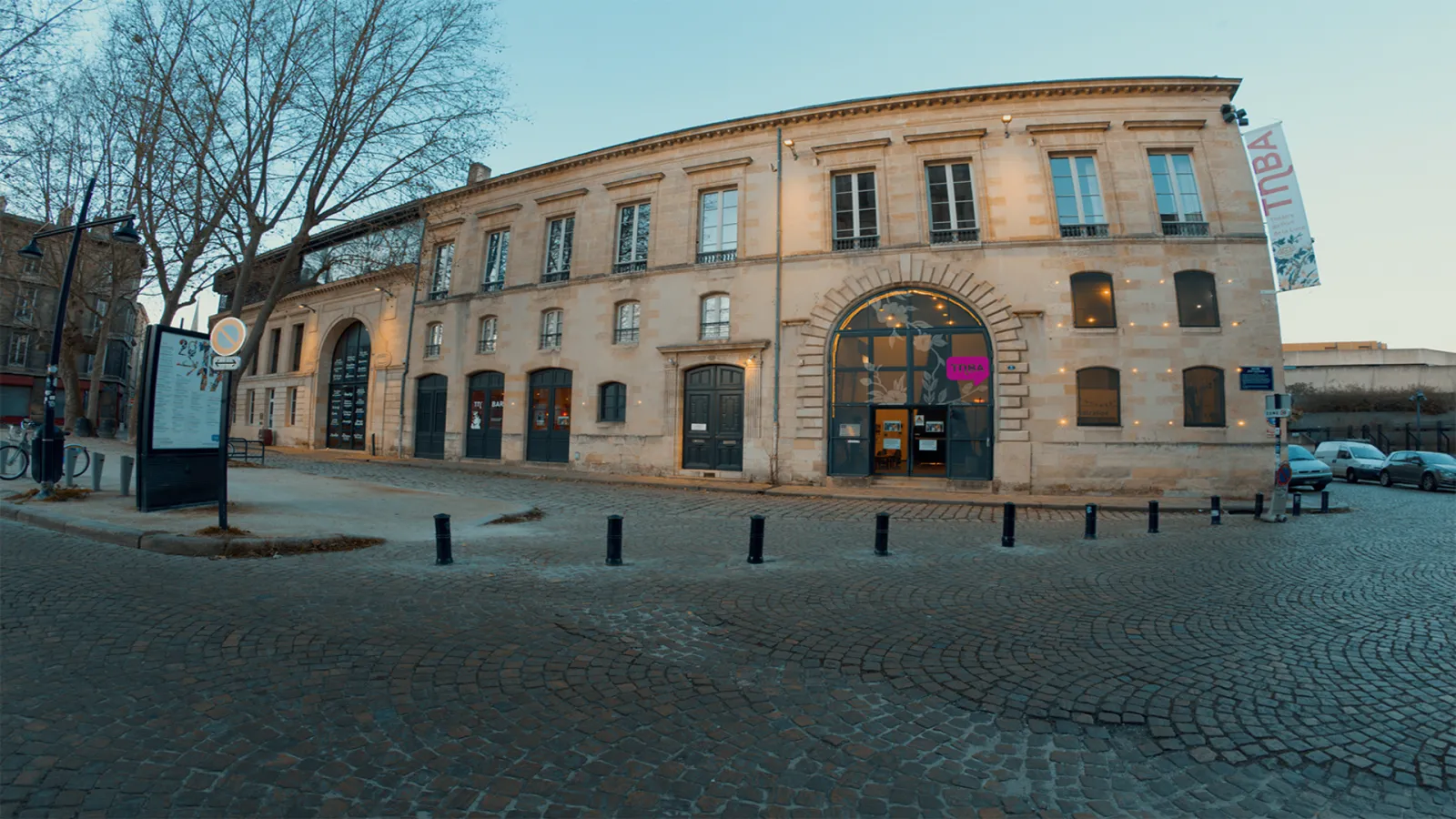 Facade of the National Theatre Bordeaux in Aquitaine, a historic stone building with a central arch and columns, located on a paved square in Bordeaux.
