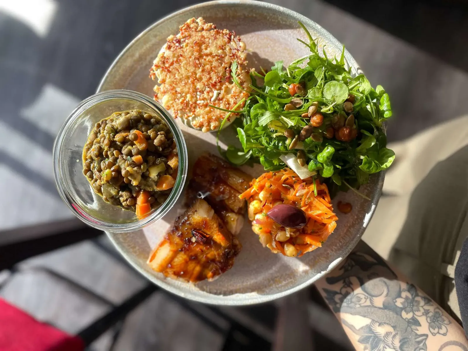 Tasting plate featuring a breaded croquette, red lentils, green salad, and two vegetable and legume-based preparations, served at Au Comptoir d'à côté in Bordeaux