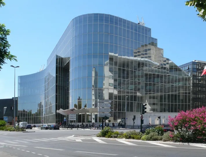 Bordeaux's Mériadeck municipal library, a contemporary building with curved glass facades and distinctive architectural structures surrounded by urban landscaping.