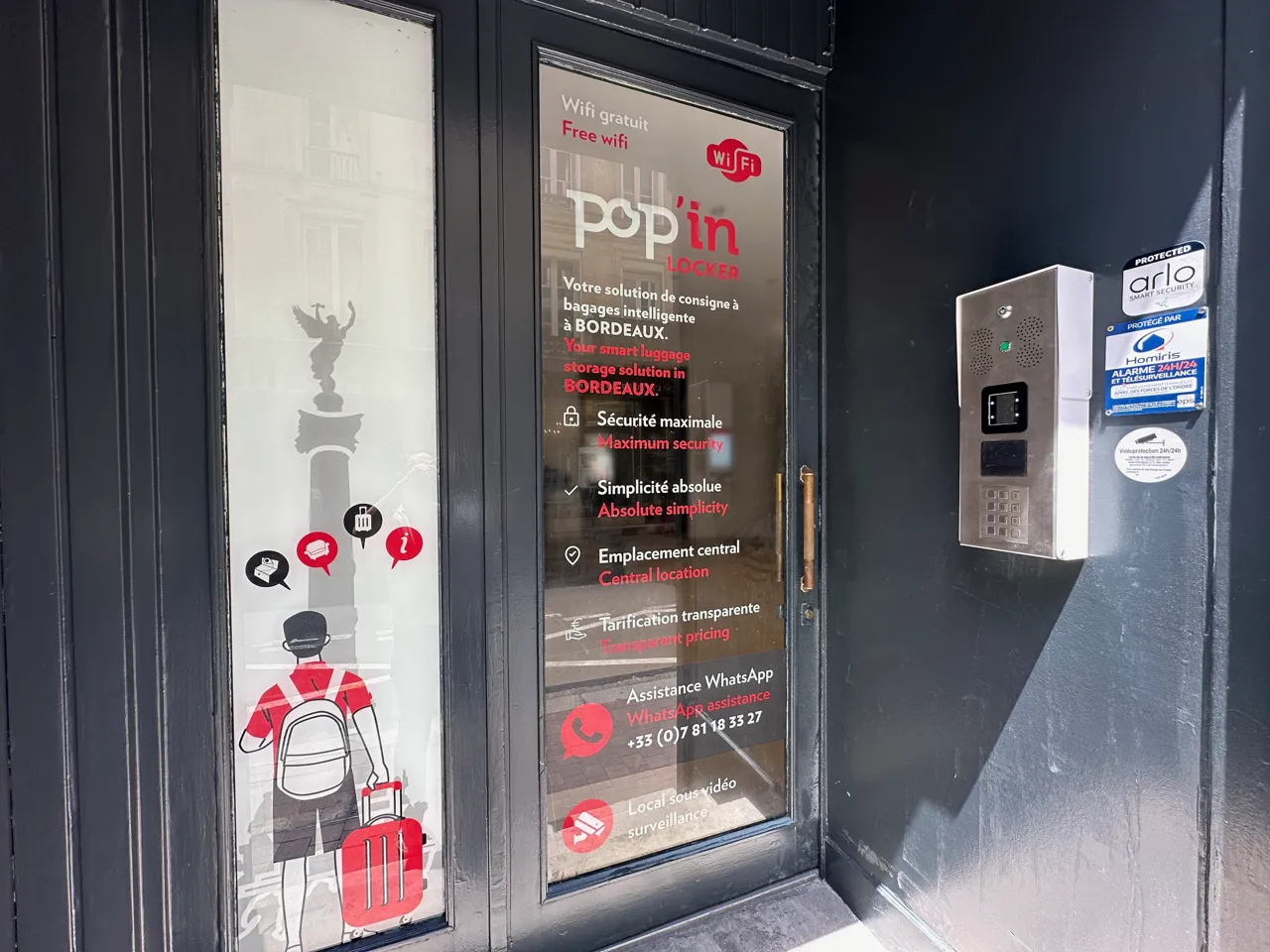 Storefront of Popin Locker service in Bordeaux, displaying key features: free wifi, maximum security, absolute simplicity, central location, with transparent pricing and WhatsApp support. An automated locker is visible on the right side of the window.