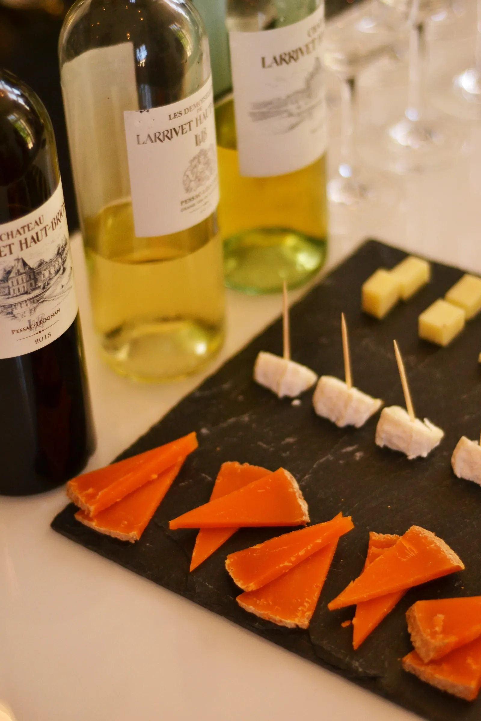 Tasting board with smoked salmon and white cheese cubes paired with Larrivet Haut-Brion white wine bottles in Bordeaux