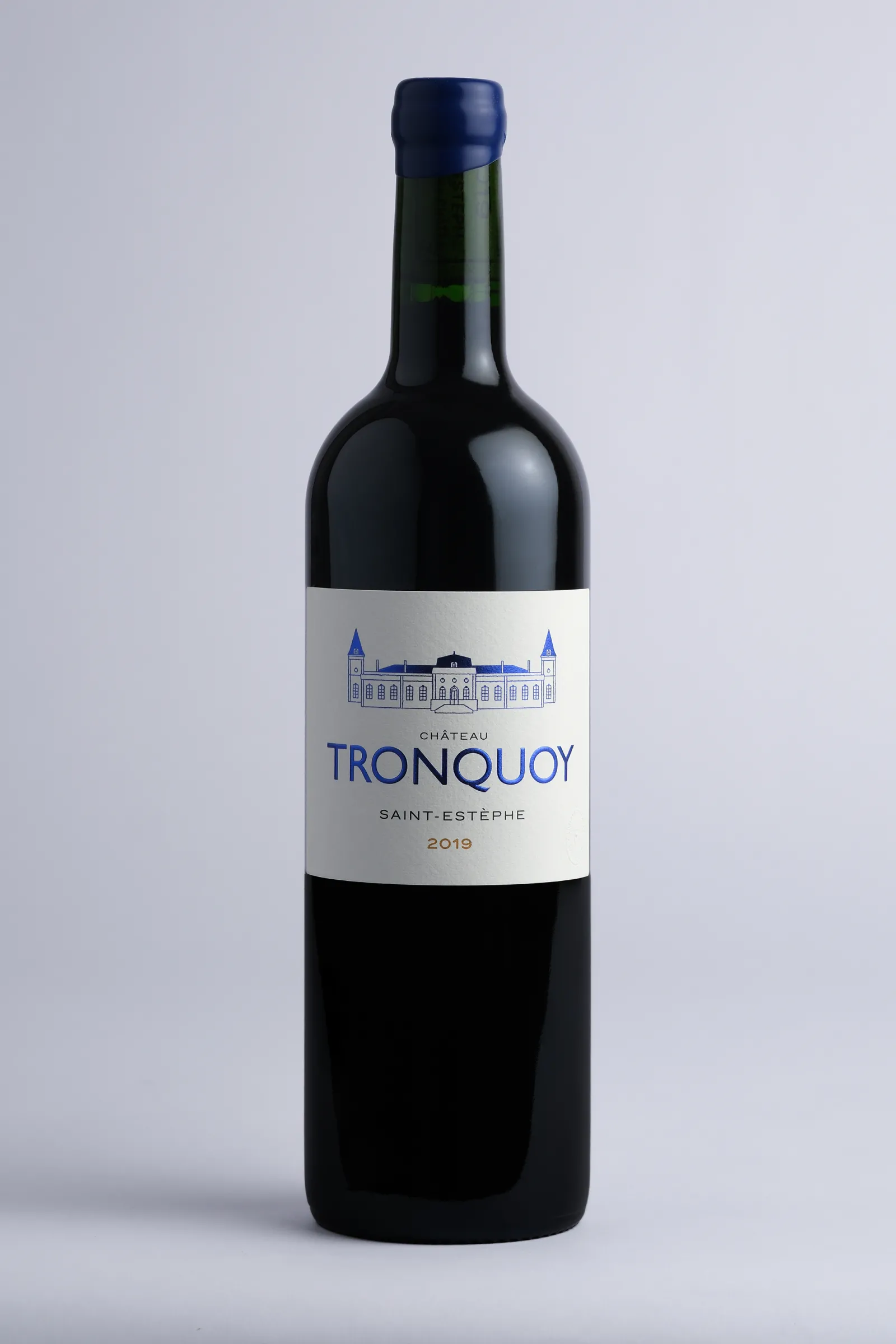 Bottle of Château Tronquoy 2019 red wine, Saint-Estèphe appellation, featuring château illustration on white label and dark blue capsule