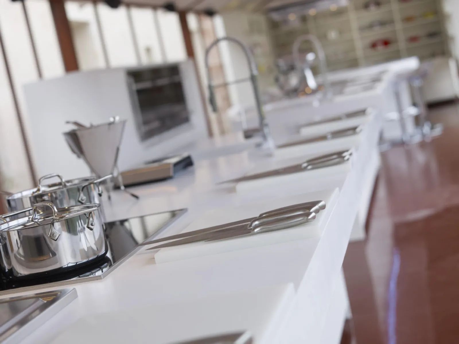 Saint-James cooking workshop in Bordeaux: white kitchen counter with professional cooking utensils, pots and culinary equipment in the background