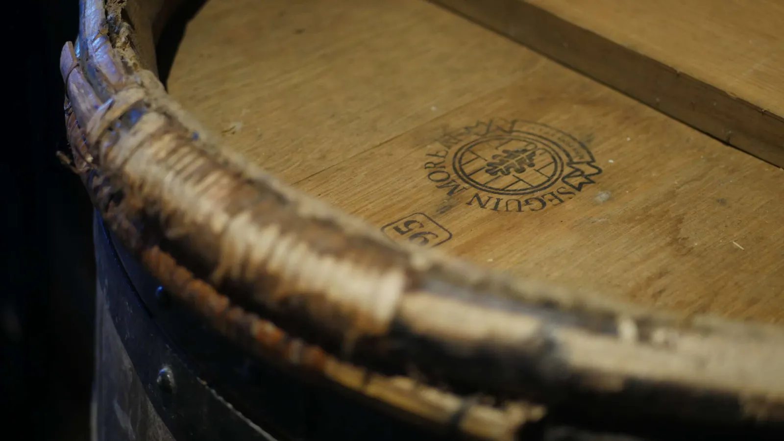 Close-up of an antique bound book with a circular seal engraved on wood, displayed at the Wine and Vineyard Ecomuseum in Gradignan near Bordeaux.