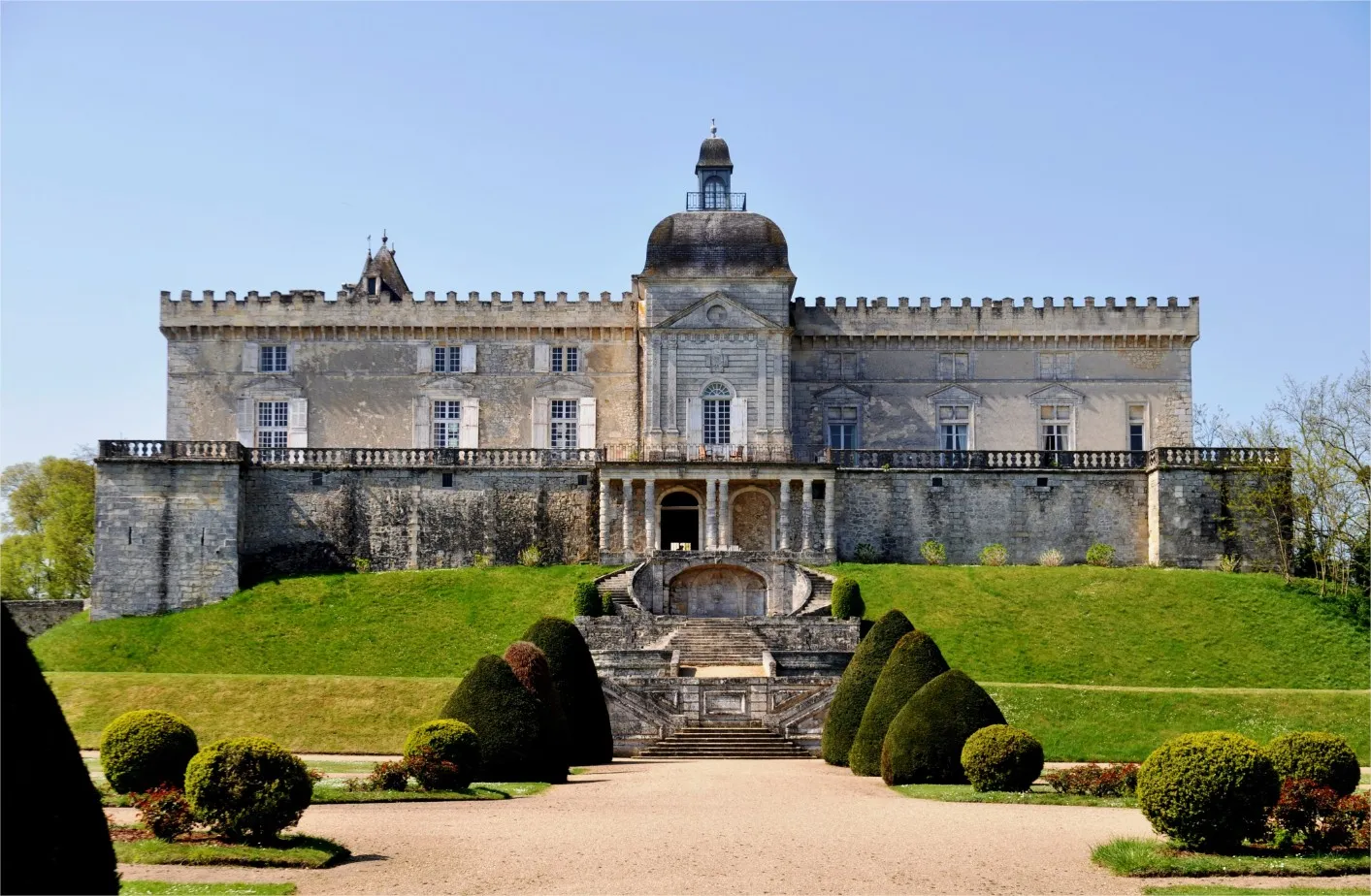 Château de Vayres near Bordeaux, a medieval fortress featuring crenellated towers, a central dome, and classical façade, surrounded by formal gardens and a monumental entrance staircase.