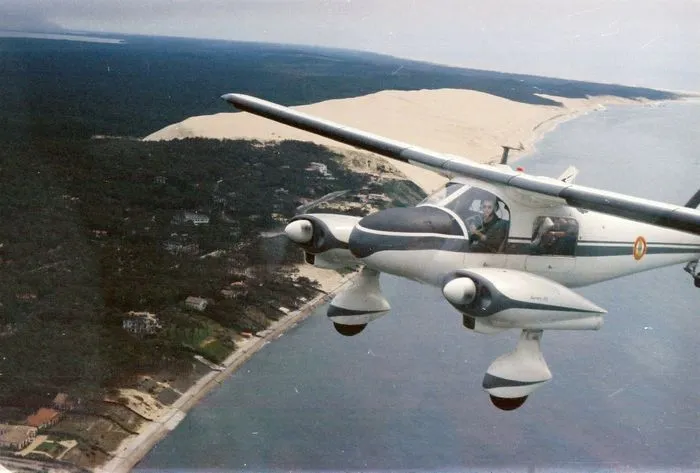 Aerial view from a customs patrol aircraft flying over the Atlantic coastline with sand dunes and coastal forest