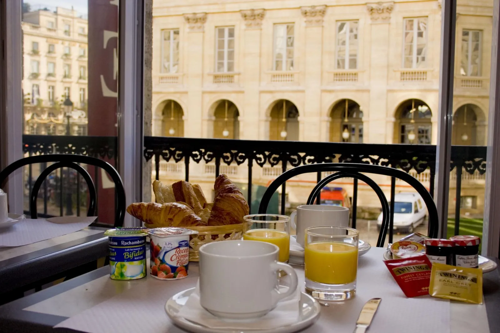 Breakfast with a view of the Opera Square in Bordeaux, featuring croissants, orange juice, coffee and jams served at the Opera Hotel