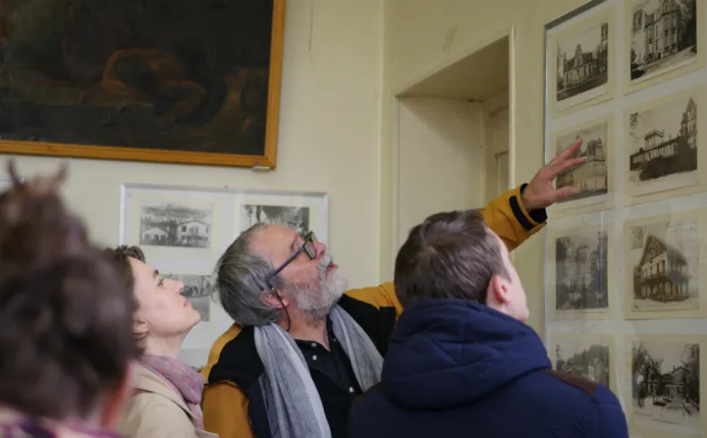 A guide shows historical engravings of Lormont to visitors at the Museum of Friends of Old Lormont in Bordeaux.
