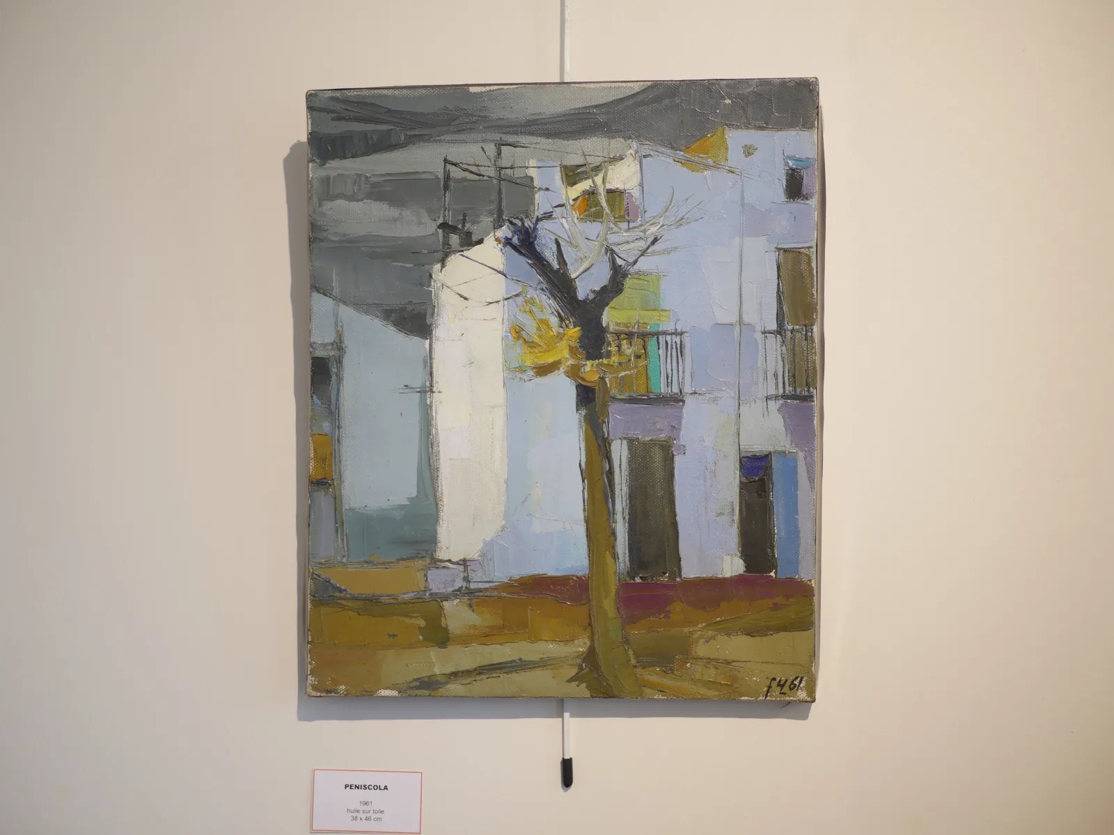 Abstract painting depicting a Bordeaux street with white and blue building facades, a black tree in the center, and yellow and ochre touches on the ground