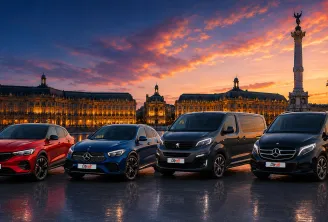 Five City rent rental vehicles displayed on Place de la Bourse in Bordeaux at sunset, featuring illuminated historic buildings and the Rostand column in the background.