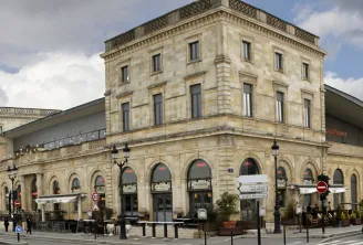 Mégarama Bordeaux Bastide cinema, a historic stone building with arched ground floor openings and regular upper floors, located in Bordeaux