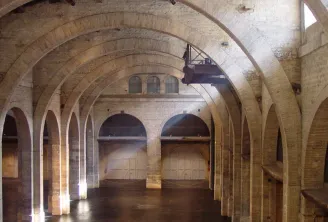 Interior of the CAPC Museum of Contemporary Art in Bordeaux featuring characteristic brick vaults and columns of a converted industrial building.