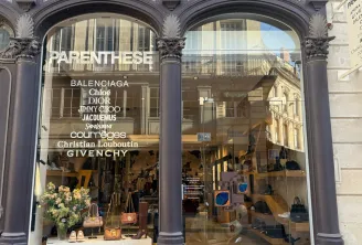 Storefront of Parenthese luxury boutique in Bordeaux featuring designer brands including Balenciaga, Chloé, Dior, Jimmy Choo, Jacquemus, Saint Laurent, Courreges, Christian Louboutin and Givenchy, with accessories and clothing on display.