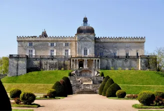 Château de Vayres near Bordeaux, a medieval fortress featuring crenellated towers, a central dome, and classical façade, surrounded by formal gardens and a monumental entrance staircase.