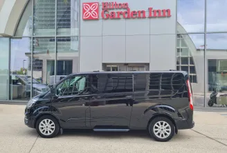 Black minivan parked in front of Hilton Garden Inn hotel in Bordeaux, VTC service
