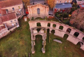 Aerial view of Palais Gallien in Bordeaux, Roman ruins with stone arches surrounded by modern buildings and vegetation