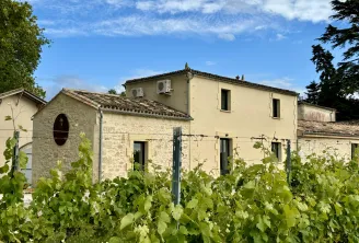 Château l'Éperon in Bordeaux: stone building with vineyard in the foreground, typical rural Bordeaux architecture