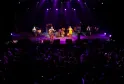 Live concert at Rock School Barbey in Bordeaux with performers on stage under purple stage lighting and audience in the foreground