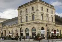 Mégarama Bordeaux Bastide cinema, a historic stone building with arched ground floor openings and regular upper floors, located in Bordeaux