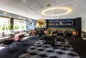 Modern reception area in Bordeaux featuring contemporary furniture, decorative shelving, innovative lighting, and city views