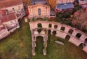 Aerial view of Palais Gallien in Bordeaux, Roman ruins with stone arches surrounded by modern buildings and vegetation