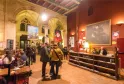 Interior of Utopia cinema in Bordeaux featuring distinctive Gothic vaulted ceilings, red and gold decor, visitors in the lobby, and the reception desk.