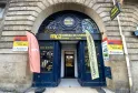 Monex Exchange currency exchange office on Victor Hugo street in Bordeaux, featuring ornate blue doors, stone arch entrance, and money transfer service signs