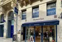 Storefront of Armor·lux shop on rue de l'Intendance in Bordeaux, featuring blue 'Change' signage, large display windows with clothing, and located in a historic stone building.