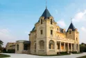 Château Léognan in Bordeaux, an elegant Second Empire mansion with limestone facade, pointed towers with black slate roofs and ornamental balustrades