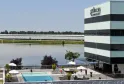 Pullman Bordeaux Lac hotel featuring striped modern architecture overlooking a water basin with outdoor swimming pool and terrace